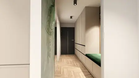Nowoczesny przedpokój z jasnymi zabudowanymi szafkami, ciemnymi drzwiami i zielonym siedziskiem. Na podłodze drewniana jodełka, a na ścianie subtelna dekoracja roślinna.