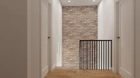Korytarz z ceglaną ścianą, białymi drzwiami i drewnianą podłogą w stylu współczesnym.
