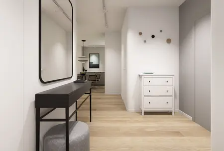 Przedpokój w stylu minimalistycznym z białymi meblami, lustrem i drewnianą podłogą.