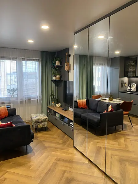 Wnętrze salonu z minimalistycznym designem, nowoczesne meble i rośliny.