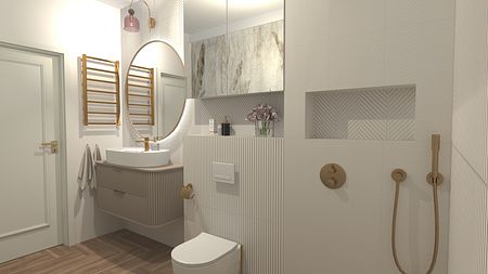 Współczesna łazienka z białymi płytkami, umywalką i złotymi detalami.