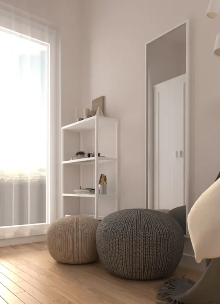 Wnętrze pokoju z białymi meblami, szarymi akcentami i minimalistycznym designem.