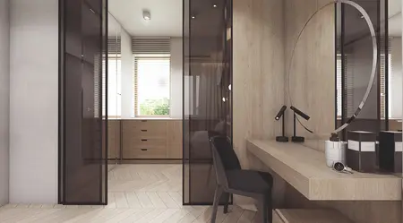 Wnętrze garderoby z drewnianymi meblami i lustrem, nowoczesny i minimalistyczny design.
