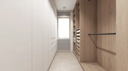 Garderoba w stylu nowoczesnym z białymi meblami i drewnianymi detalami.