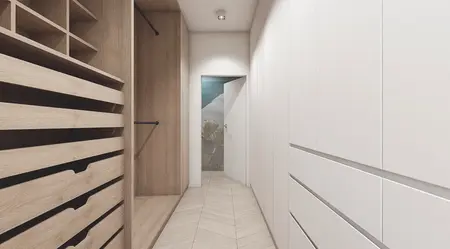 Garderoba w stylu nowoczesnym z białymi meblami i drewnianymi akcentami.