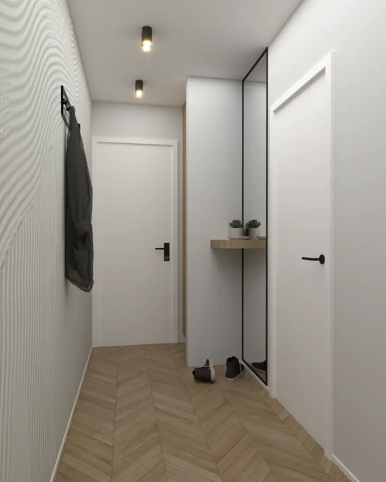 Nowoczesny przedpokój z minimalistycznymi akcentami i drewnianą podłogą.
