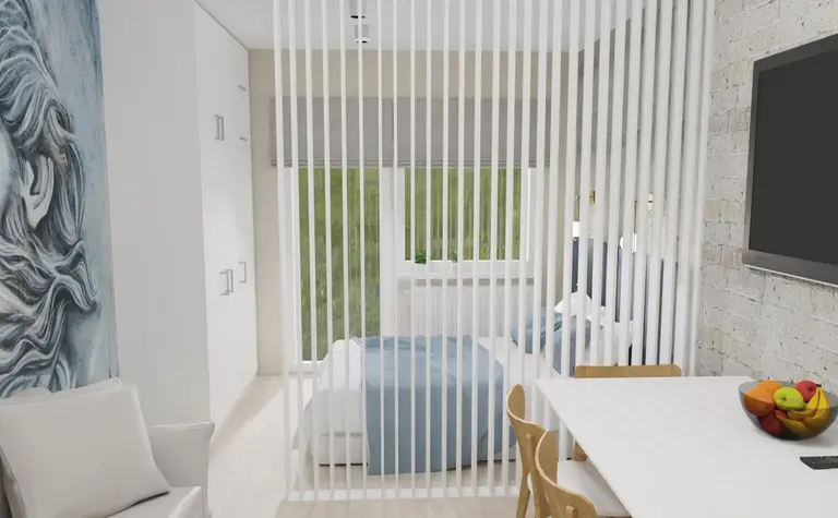 Sypialnia w stylu minimalistycznym z niebieską pościelą i białymi meblami