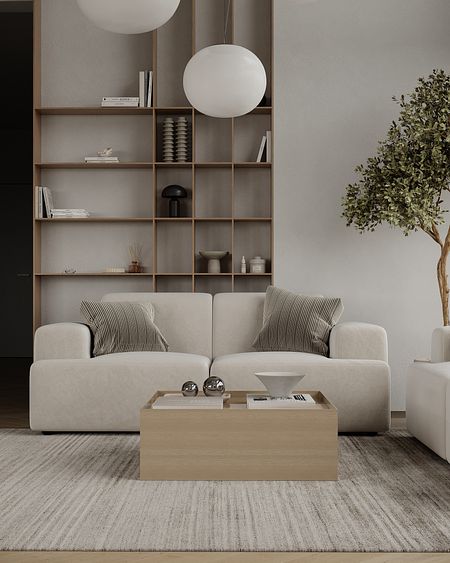 Wnętrze salonu w stylu japandi z minimalistycznym wystrojem, jasną sofą i drewnianymi akcentami.