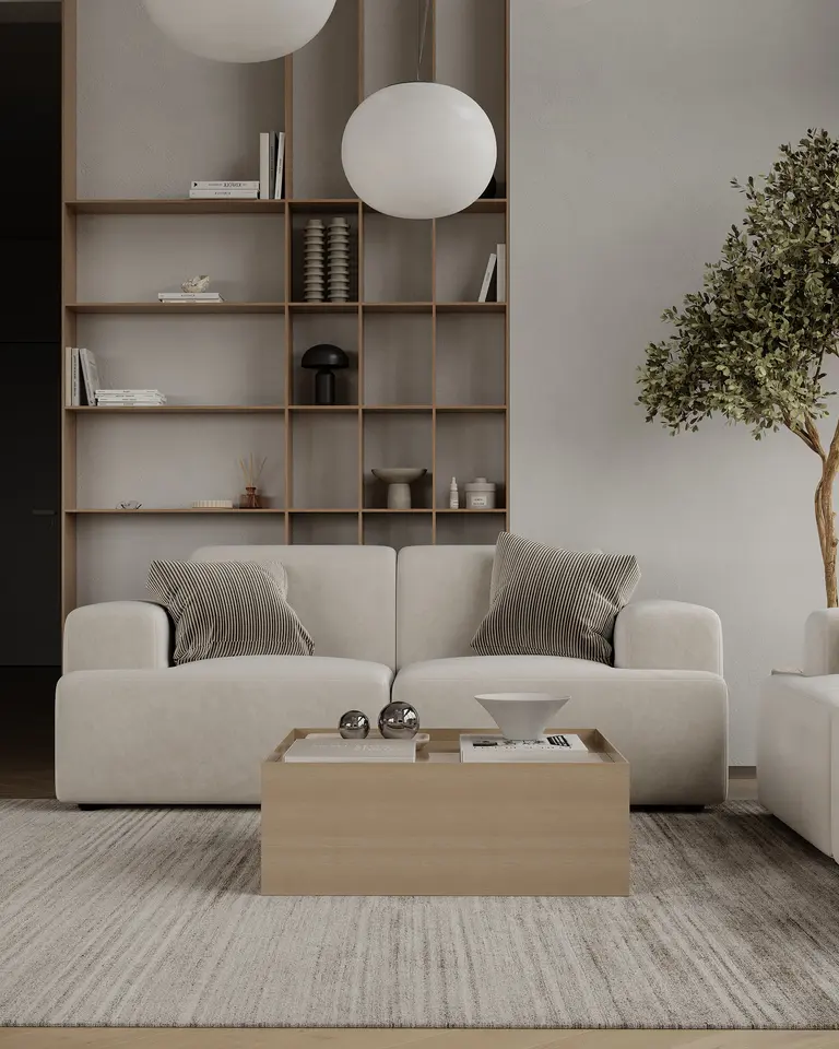 Wnętrze salonu w stylu japandi z minimalistycznym wystrojem, jasną sofą i drewnianymi akcentami.