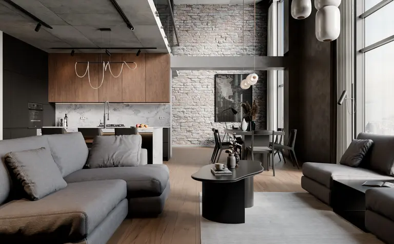 Wnętrze w stylu industrialnym z szarymi meblami, drewnianym blatem i dużymi oknami.