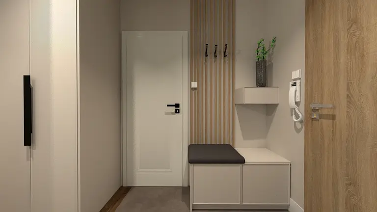 Przedpokój z białą szafą, drewnianymi detalami i rośliną.