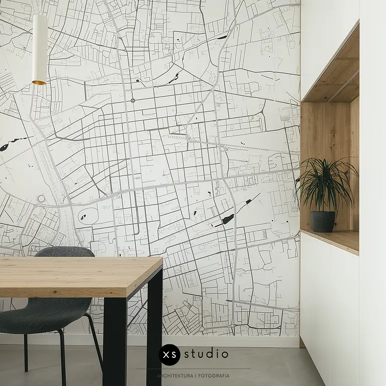 Wnętrze jadalnii w stylu minimalistycznym i skandynawskim z mapą i rośliną