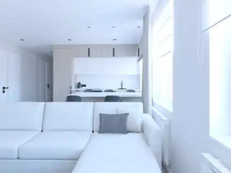 Wnętrze salonu z białą sofą, minimalistyczną kuchnią i industrialnymi akcentami.
