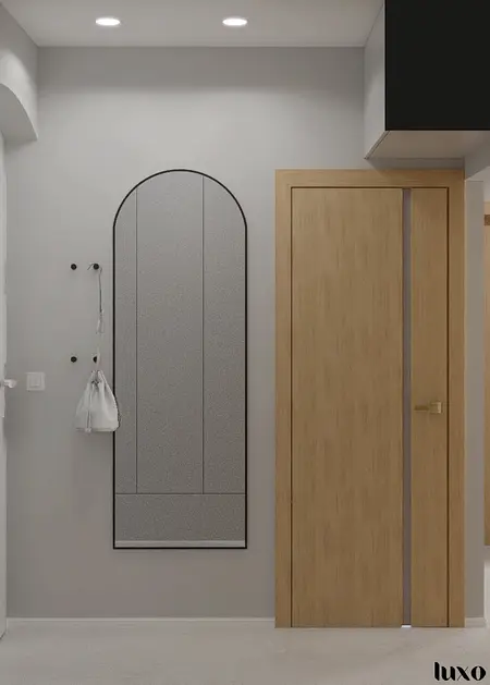 Przedpokój w stylu japandi, minimalistycznym i nowoczesnym z drewnianymi elementami.