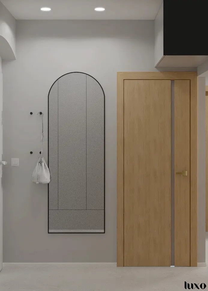 Przedpokój w stylu japandi, minimalistycznym i nowoczesnym z drewnianymi elementami.