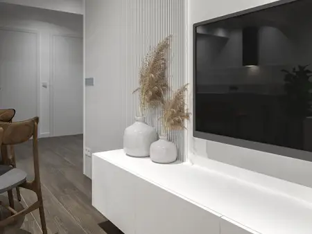 Nowoczesne wnętrze z białą szafką, telewizorem i roślinami