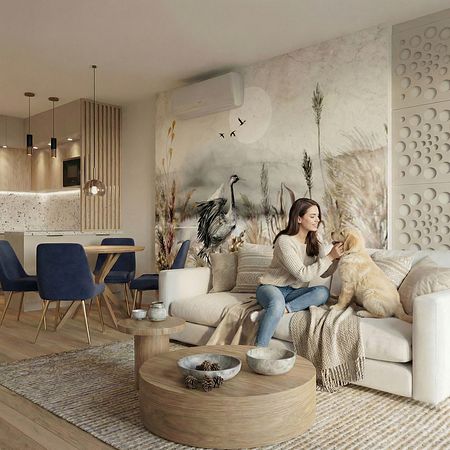 Wnętrze salonu w stylu minimalistycznym z jasnymi meblami i nowoczesnymi detalami.