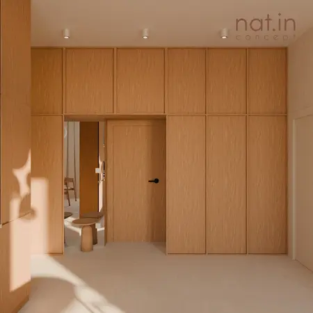 Przedpokój w stylu japandi z drewnianymi meblami i naturalnym światłem.