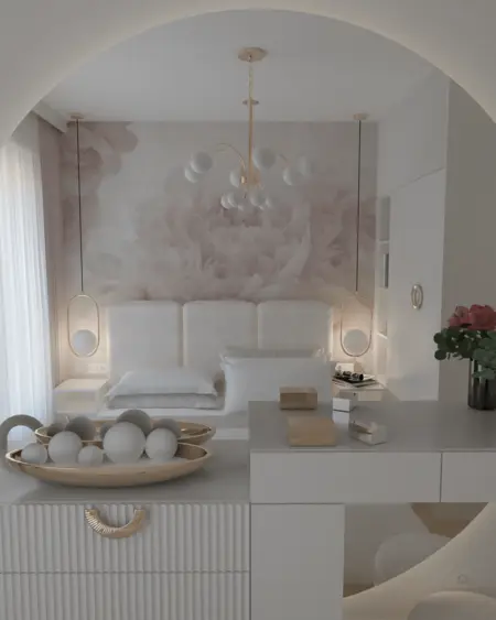 Sypialnia z białym łóżkiem, złotymi lampami i dekoracjami w stylu glamour i nowoczesnym.