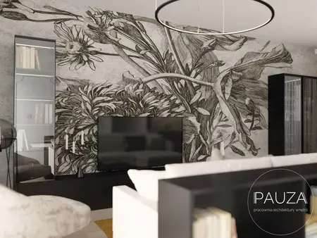 Nowoczesny salon z telewizorem i muralem roślinnym na ścianie.
