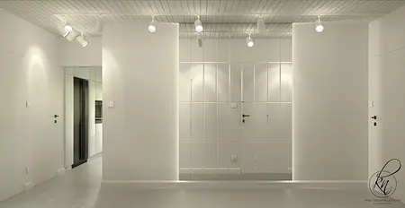 Minimalistyczne wnętrze z białymi ścianami i czarnymi akcentami.