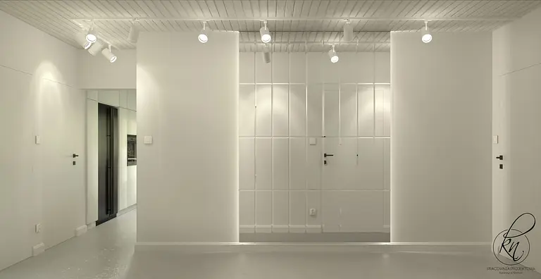 Minimalistyczne wnętrze z białymi ścianami i czarnymi akcentami.