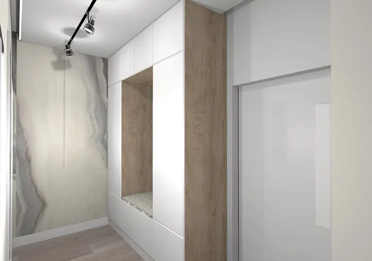 Nowoczesna garderoba z białymi meblami, drewnianymi detalami i minimalistycznym wykończeniem.