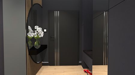 Przedpokój w stylu industrialnym z szarymi ścianami, drewnianą podłogą i nowoczesnym lustrem.