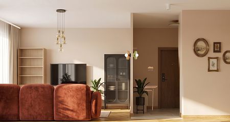 Wnętrze salonu w stylu art deco i boho z brązową sofą.