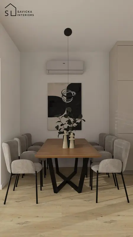 Elegancka jadalnia z drewnianym stołem, szarymi tapicerowanymi krzesłami i minimalistyczną lampą wiszącą nad stołem.