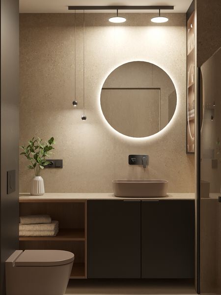 Nowoczesna łazienka z okrągłym lustrem, minimalistycznym designem i naturalnymi materiałami.