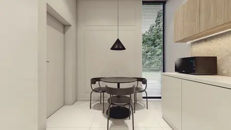 Nowoczesne wnętrze kuchni z minimalistycznym stołem i krzesłami.