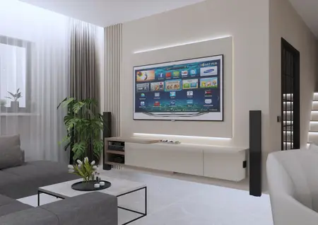 Wnętrze salonu z szarymi meblami, telewizorem i roślinami, minimalistyczny styl.