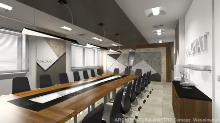 Wnętrze sali konferencyjnej z drewnianym stołem i szarymi akcentami.