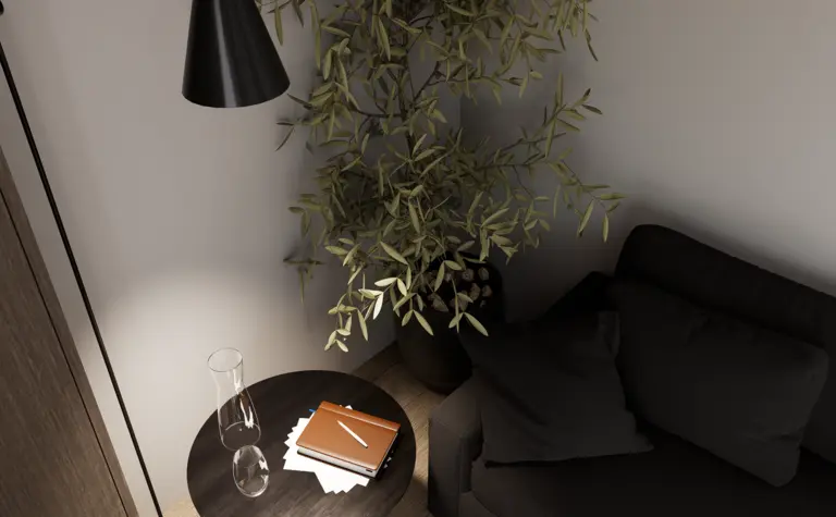 Wnętrze salonu z minimalistycznym designem, czarną sofą, drewnianym stolikiem oraz roślinnością.