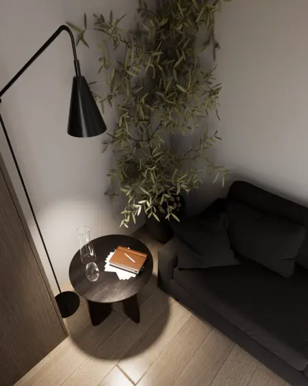 Wnętrze salonu z minimalistycznym designem, czarną sofą, drewnianym stolikiem oraz roślinnością.