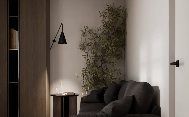 Wnętrze w stylu minimalistycznym z czarną sofą, drewnianymi meblami i roślinnością.