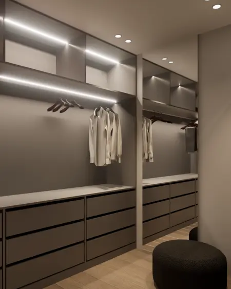 Garderoba z minimalistycznym designem, nowoczesnymi meblami i oświetleniem.
