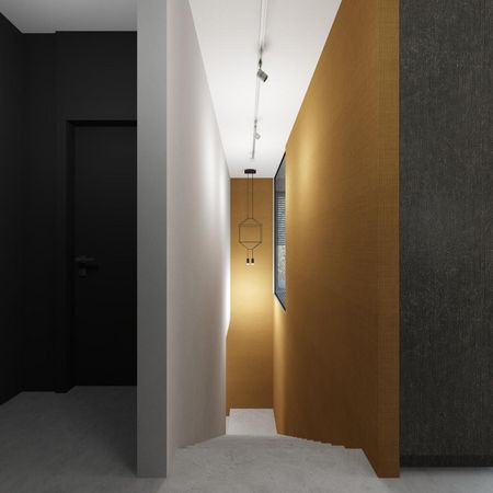 Korytarz w stylu industrialnym z czarną ścianą i złotą tapetą