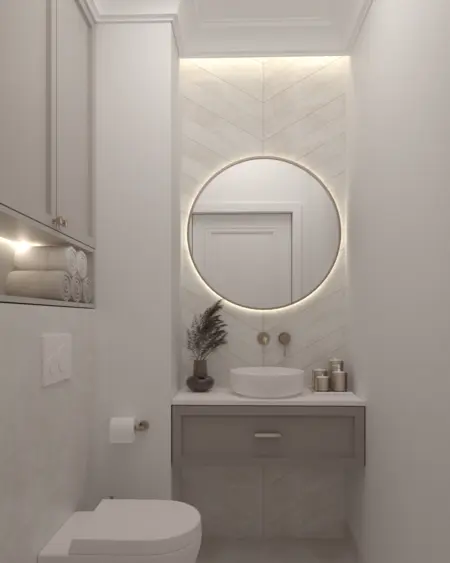 Nowoczesna łazienka z okrągłym lustrem, jasnymi płytkami i eleganckim umywalką w stylu quiet luxury.