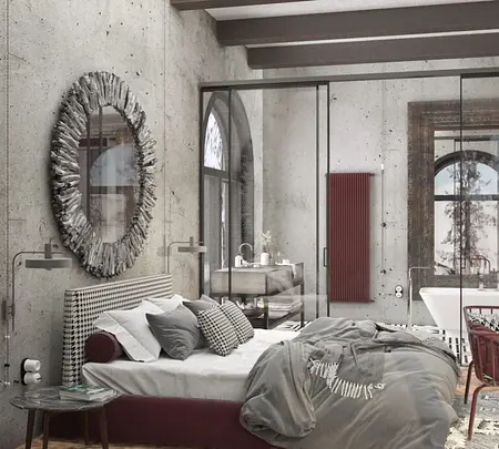 Sypialnia w stylu industrialnym z szarymi ścianami, nowoczesnym łóżkiem i dekoracyjnym lustrem.