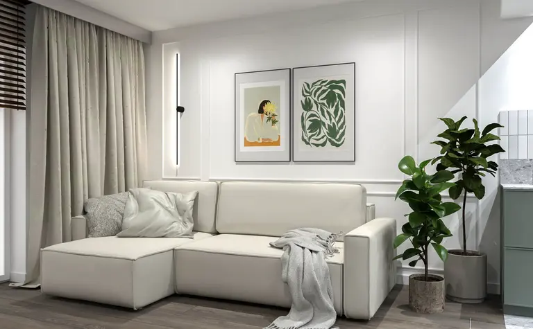 Wnętrze salonu z białą sofą, zielonymi roślinami i minimalistycznymi detalami.