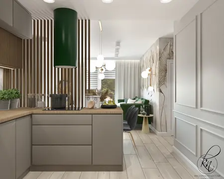 Wnętrze kuchni z zielonym okapem, drewnianymi detalami i nowoczesnym stylem.