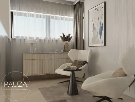 Nowoczesne wnętrze salonu z jasnymi fotelami, minimalistyczną szafką oraz dużymi oknami.