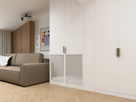 Wnętrze minimalistycznego salonu z szarym narożnikiem i drewnianymi detalami.