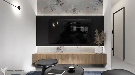Wnętrze salonu z telewizorem, drewnianymi meblami i minimalistycznymi akcentami.