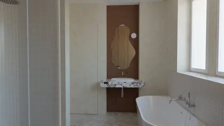 Wnętrze łazienki w stylu minimalistycznym z marmurową umywalką i wanną.