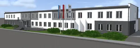 Widok budynku z szaro-białą elewacją i zielonymi krzewami, styl industrialny i nowoczesny.