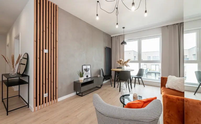 Wnętrze salonu w stylu industrialnym i minimalistycznym z brązowymi akcentami.