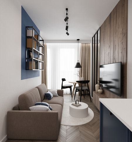 Wnętrze minimalistycznego salonu z brązową sofą i niebieskimi detalami.